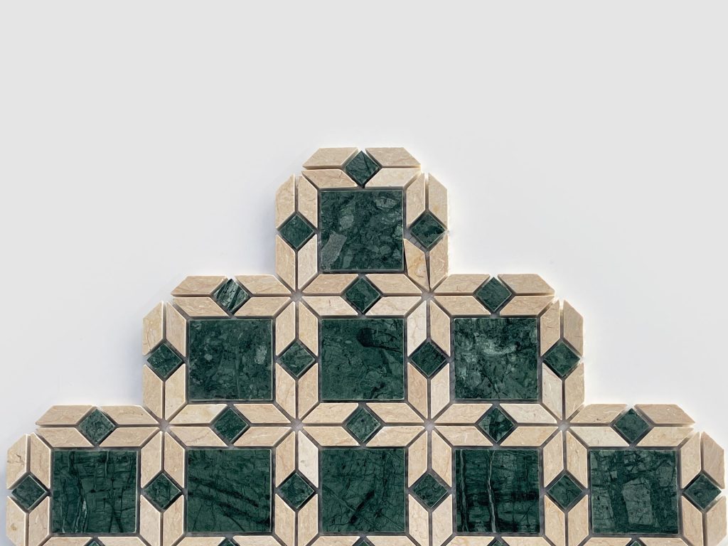 A geometric tile pattern featuring green marble squares bordered by beige tiles, arranged in a stair-step pyramid shape against a plain white background.