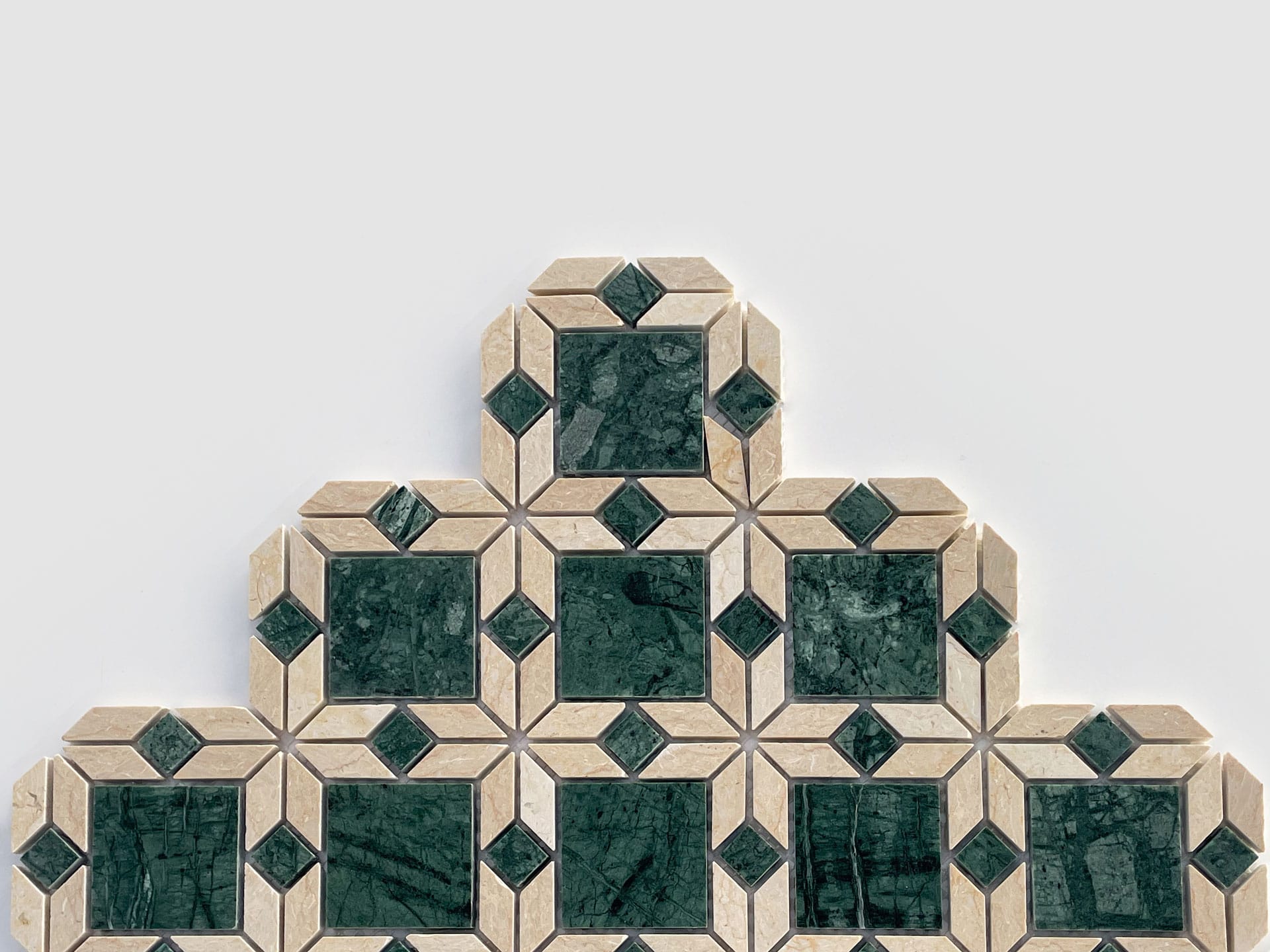 A geometric tile pattern featuring green marble squares bordered by beige tiles, arranged in a stair-step pyramid shape against a plain white background.