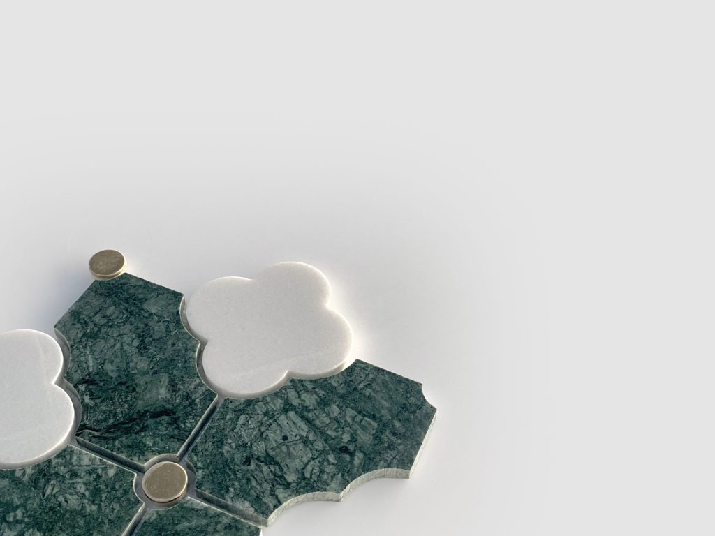 A geometric arrangement of green marble tiles and white clover-shaped tiles with small round gold accents, set against a plain light gray background.